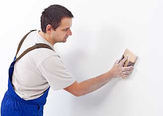 Painter preparing the wall surface