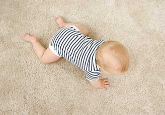 baby crawling on carpet